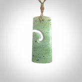 Hand made New Zealand Kokopu jade toki with koru pendant. Hand carved in New Zealand by Kerry Thompson. Hand made jewellery. Unique Jade Toki with adjustable cord. Free shipping worldwide.
